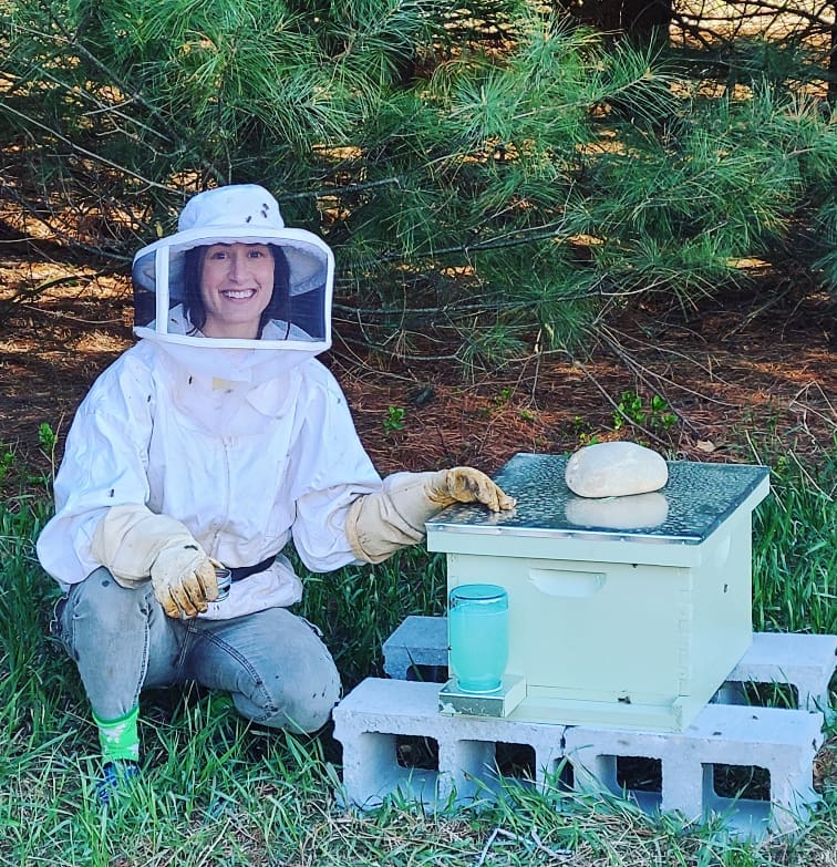 Woman and bee hive