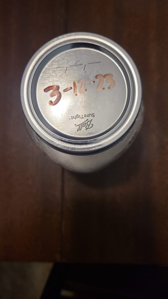 Labeled Mason jar storing refrigerated goat's milk 