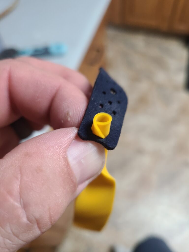 Folding and inserting latex into slingshot pouch
