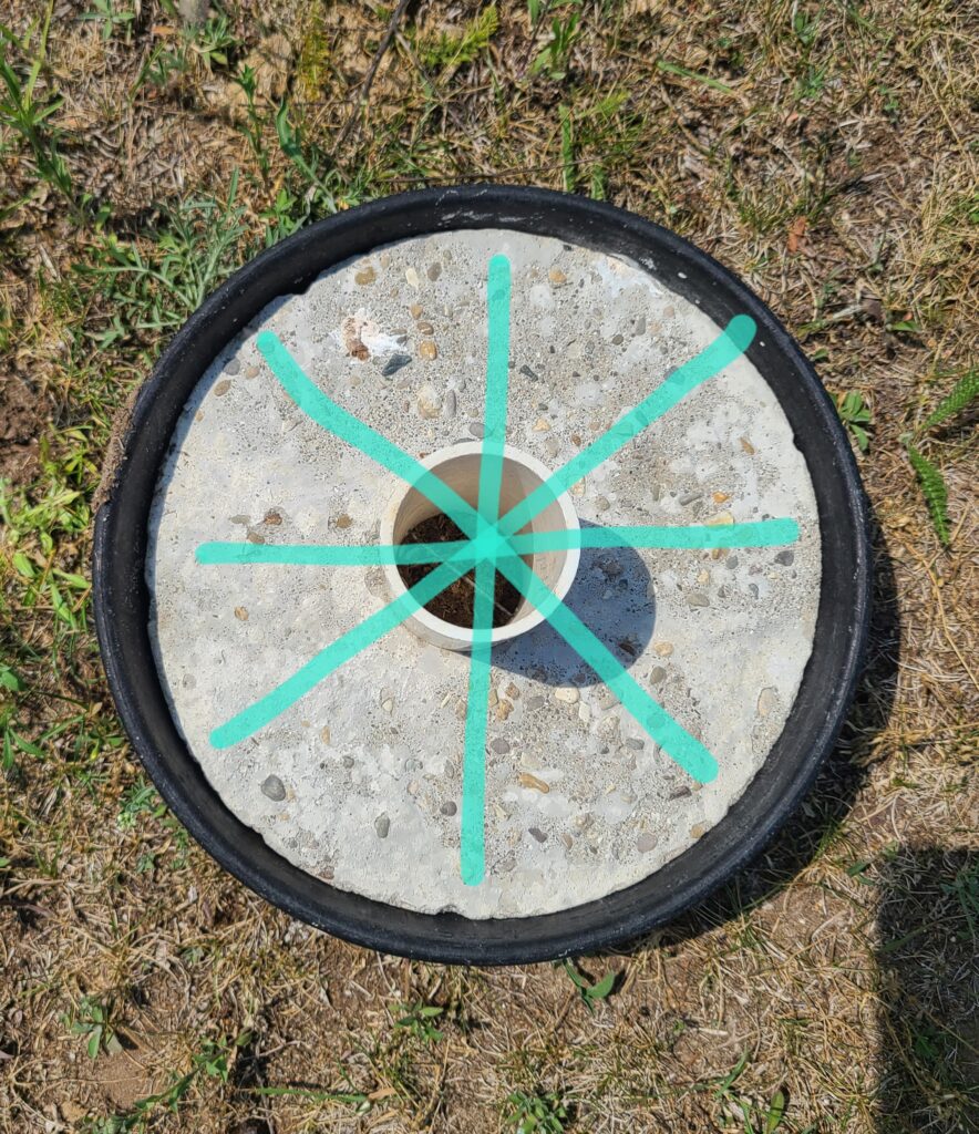 Rubber feed pan filled with concrete showing the location of the buried wires