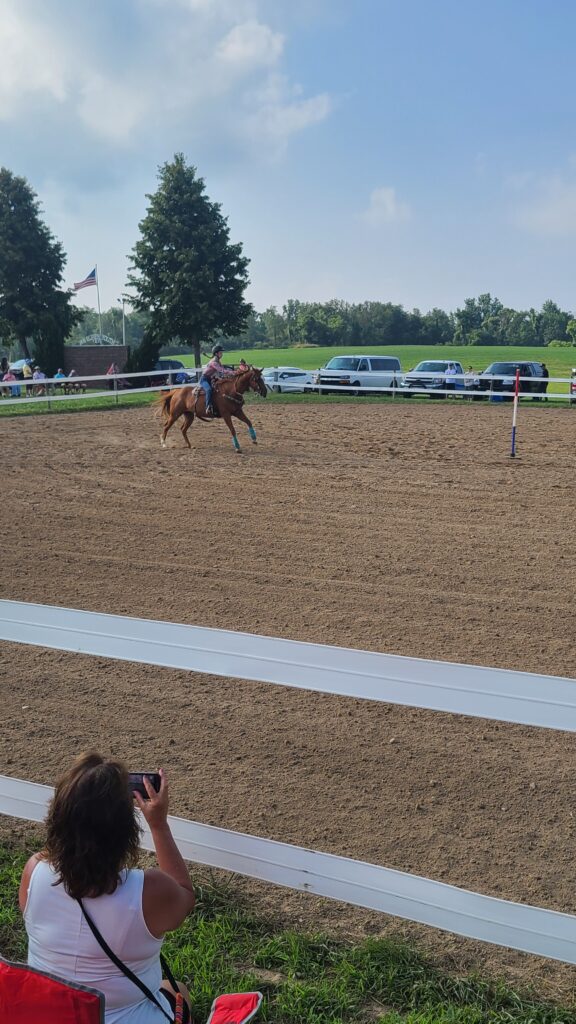 Girl pole bending on a horse