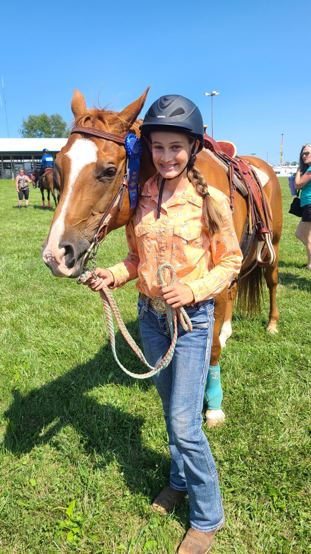 Girl with horse and a blue ribbon
