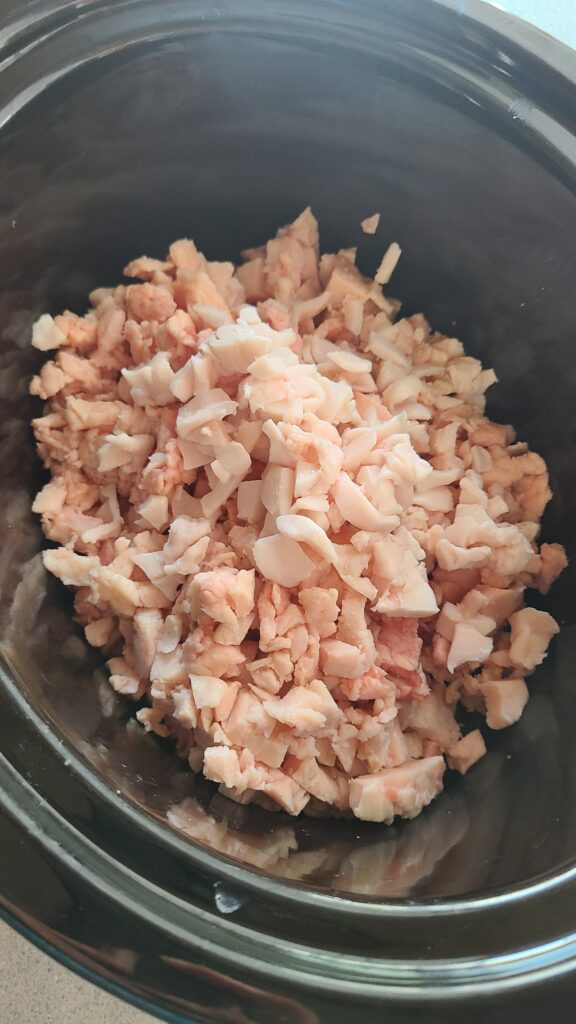 Cut up pork fat to render lard in a slow cooker