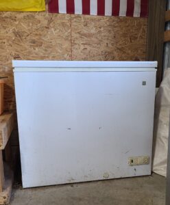 chest freezer in a barn for storing grain