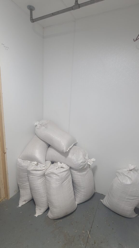 Walk-in cooler storing bags of feed as mouse-proof grain storage
