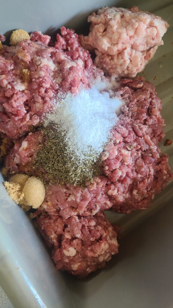 Ground pork, pork fat, and seasonings for making sausage