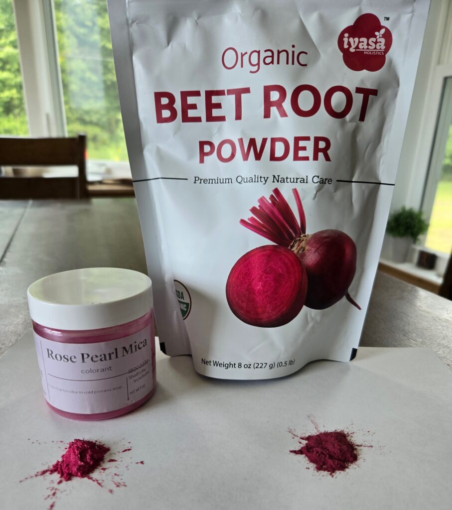 Container of rose pearl mica powder and bag of organic beet root powder sitting on a table.