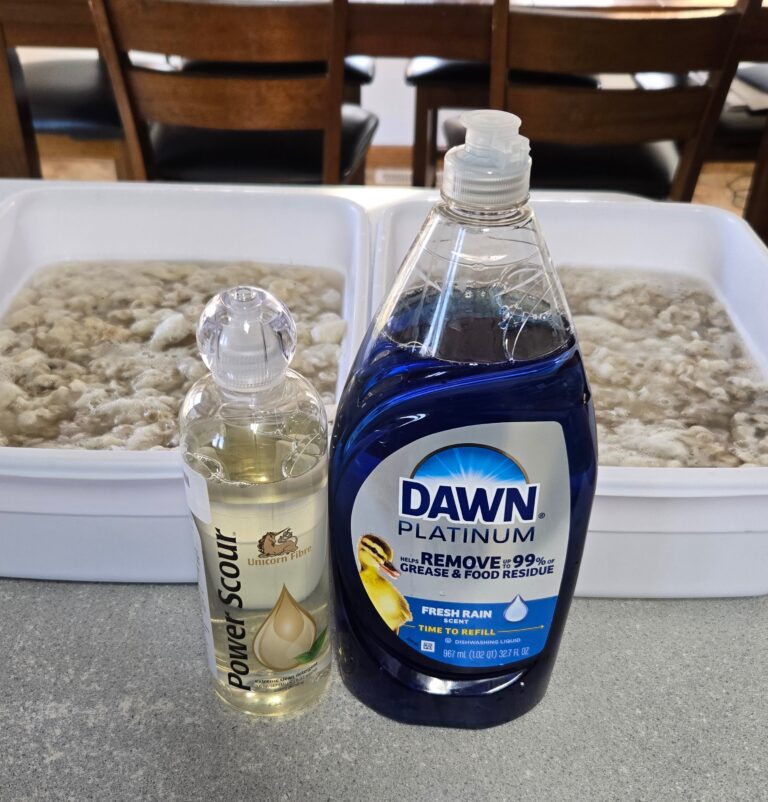 Two totes of mohair fleece being soaked with Power Scour and Dawn dish soap in front of them.