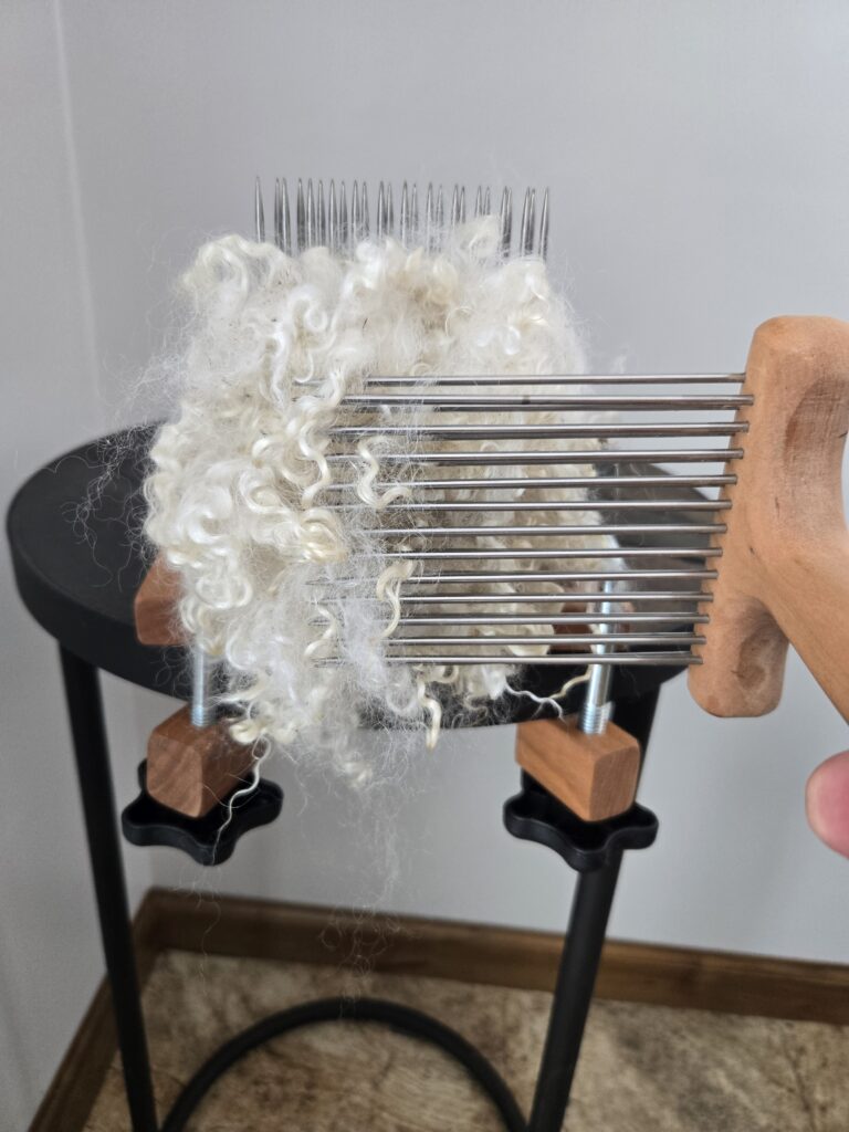 Wool combs aligned for combing the fiber on the hackle at the ends