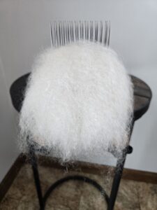 Combed mohair on a stationary English comb.