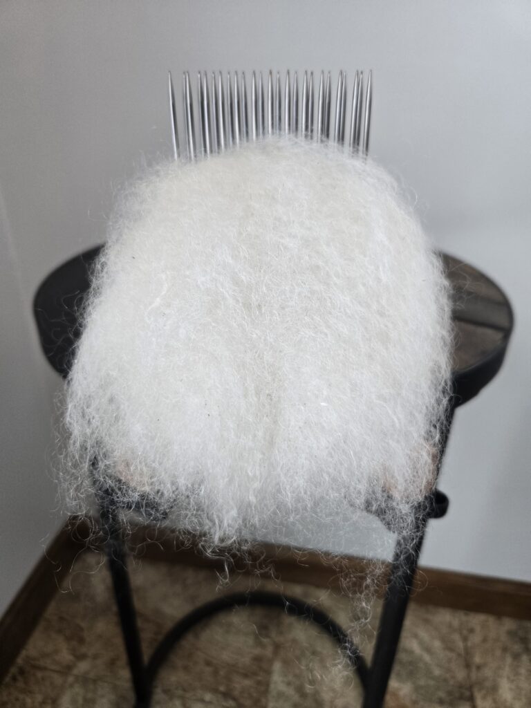 Combed mohair on a stationary English comb.