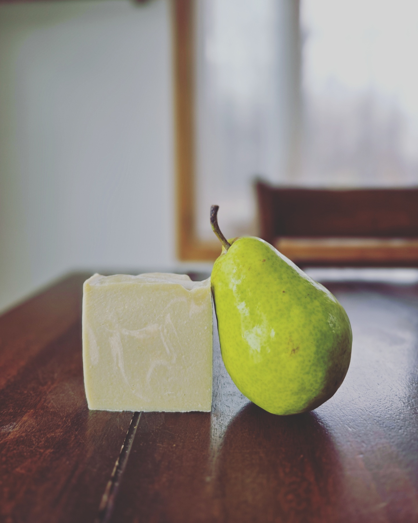 Handmade green soap and a green pear