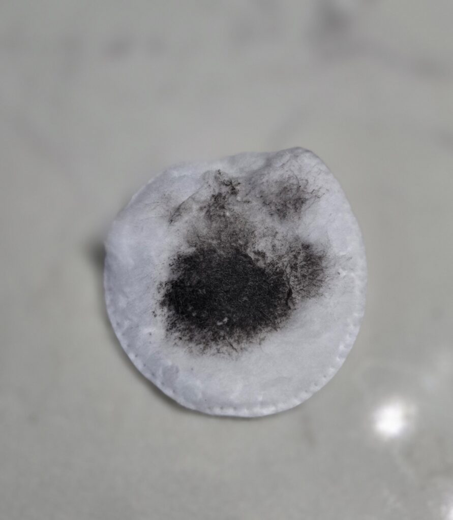 Cotton round with makeup on it.