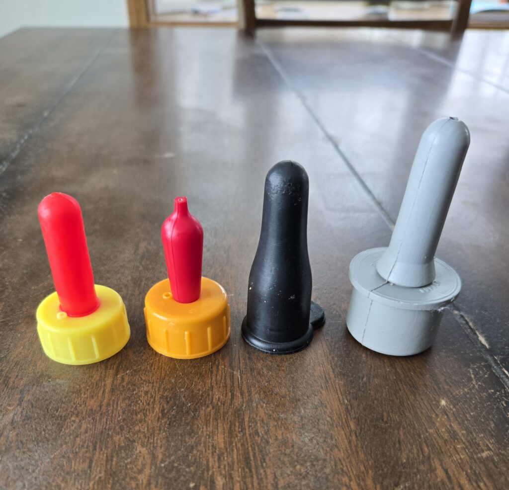 Four different types of nipples that can be used for bottle-feeding baby goats.
