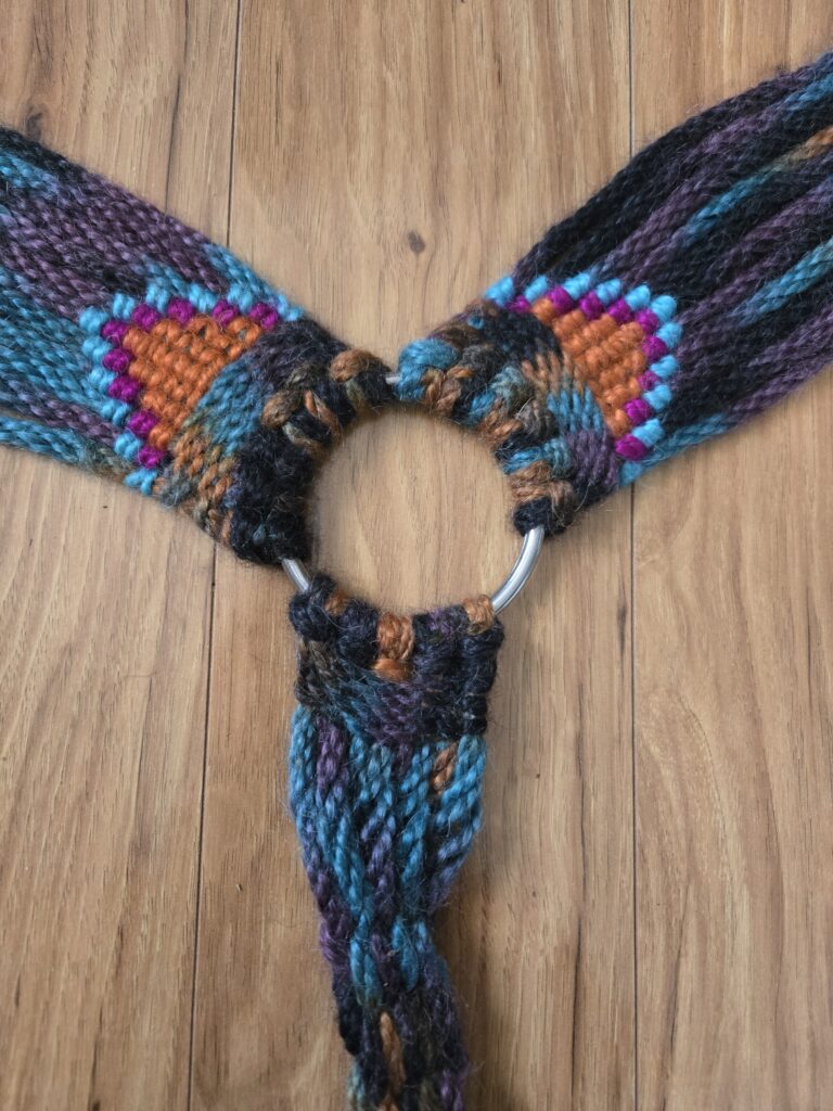 Close-up of the center of a hand-woven mohair breast collar.