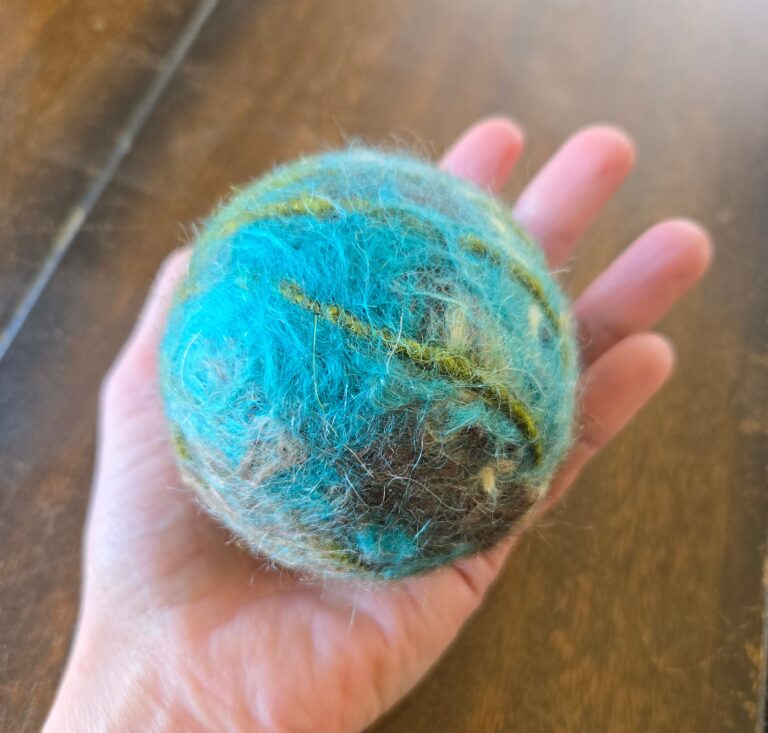 Felted dryer ball made with recycled scrap yarn.