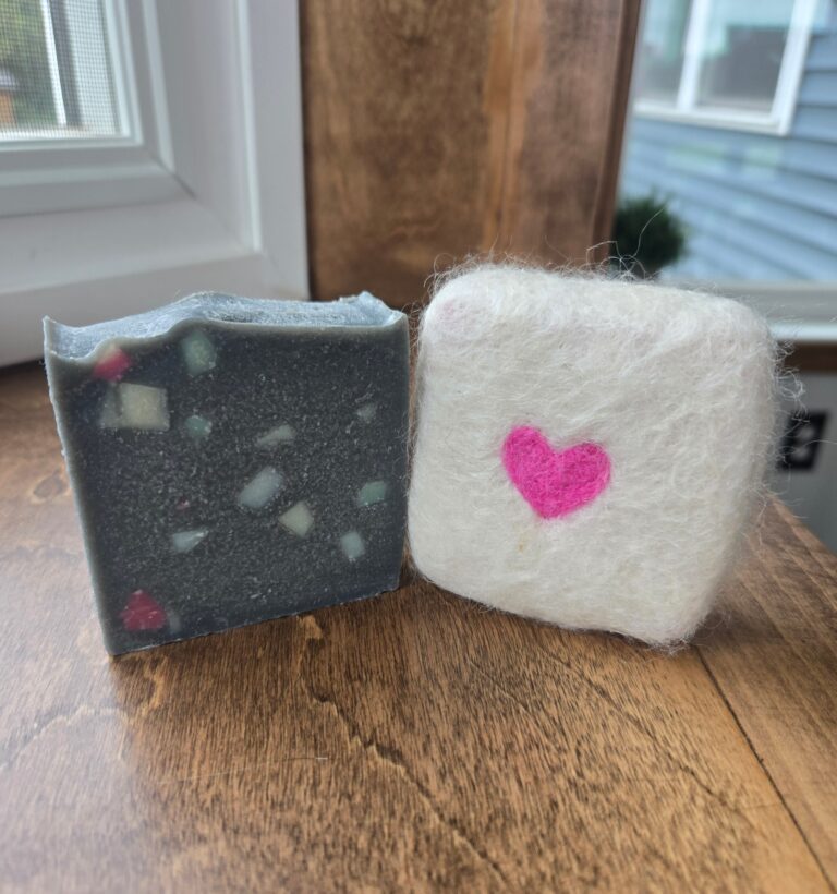 Mosaic and felted soap sitting on a window sill.
