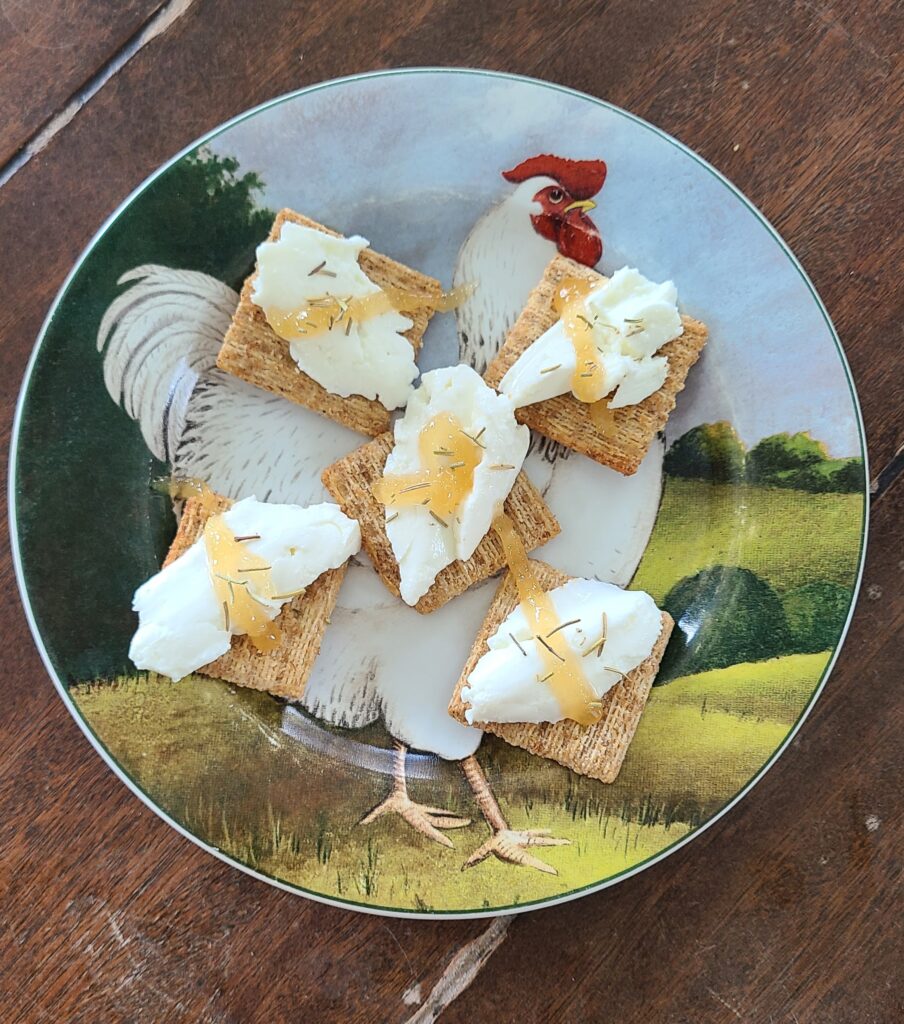 A plate of goat cheese on crackers.
