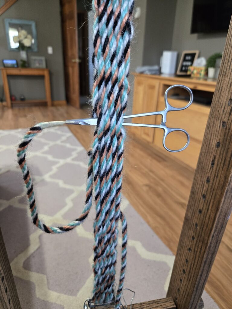 Hemostats being used for weaving