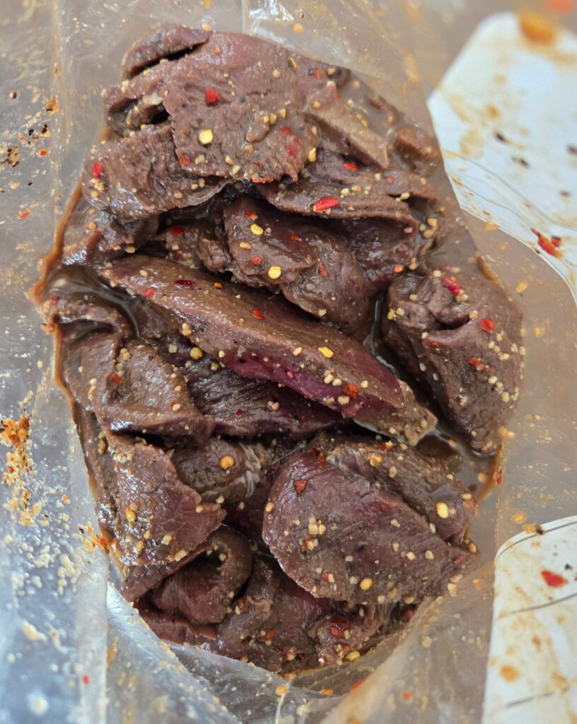 Meat marinating in a zip lock bag.