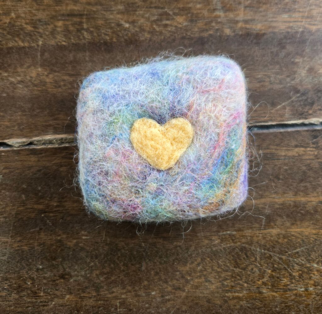 Felted soap with a heart on it.
