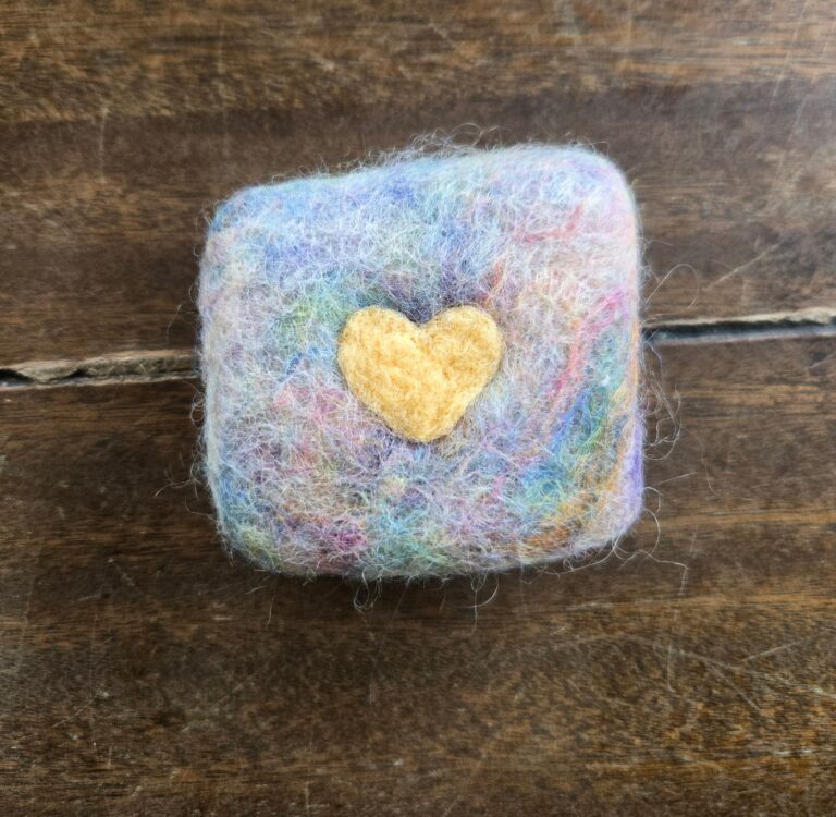 Felted soap with a heart on it.