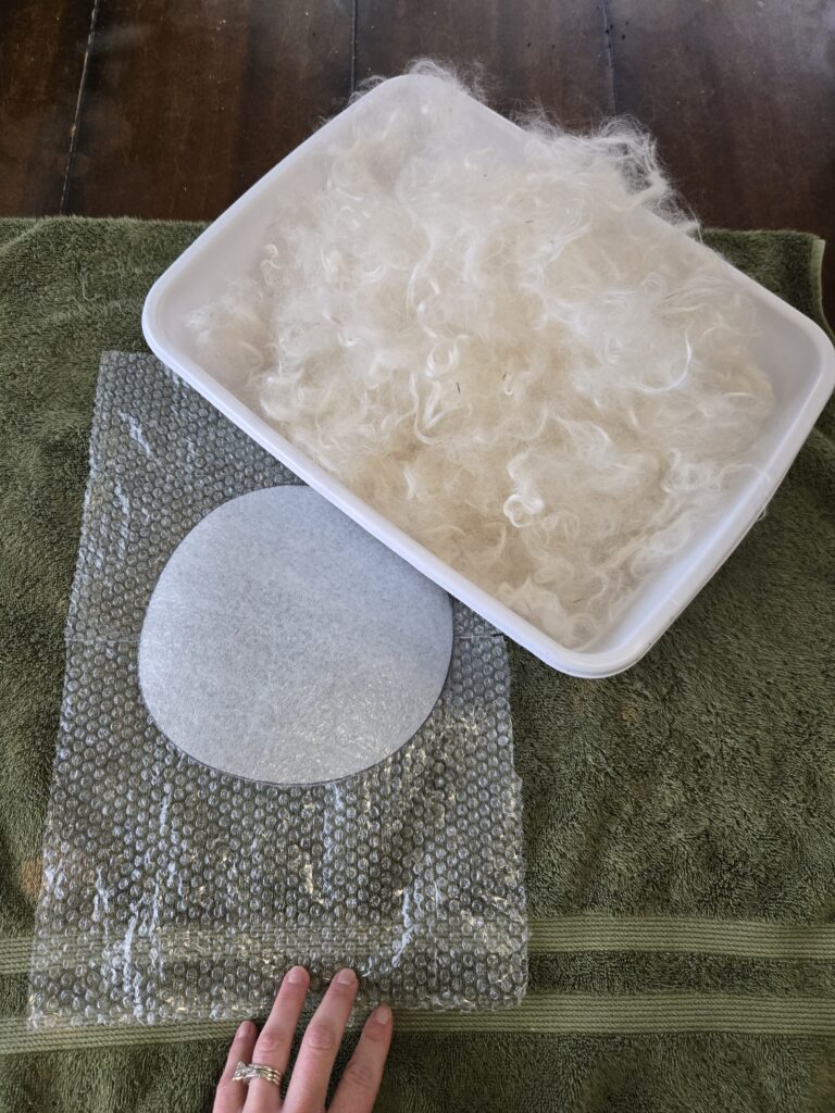 Fiber, a resist, and bubble wrap for wet felting.