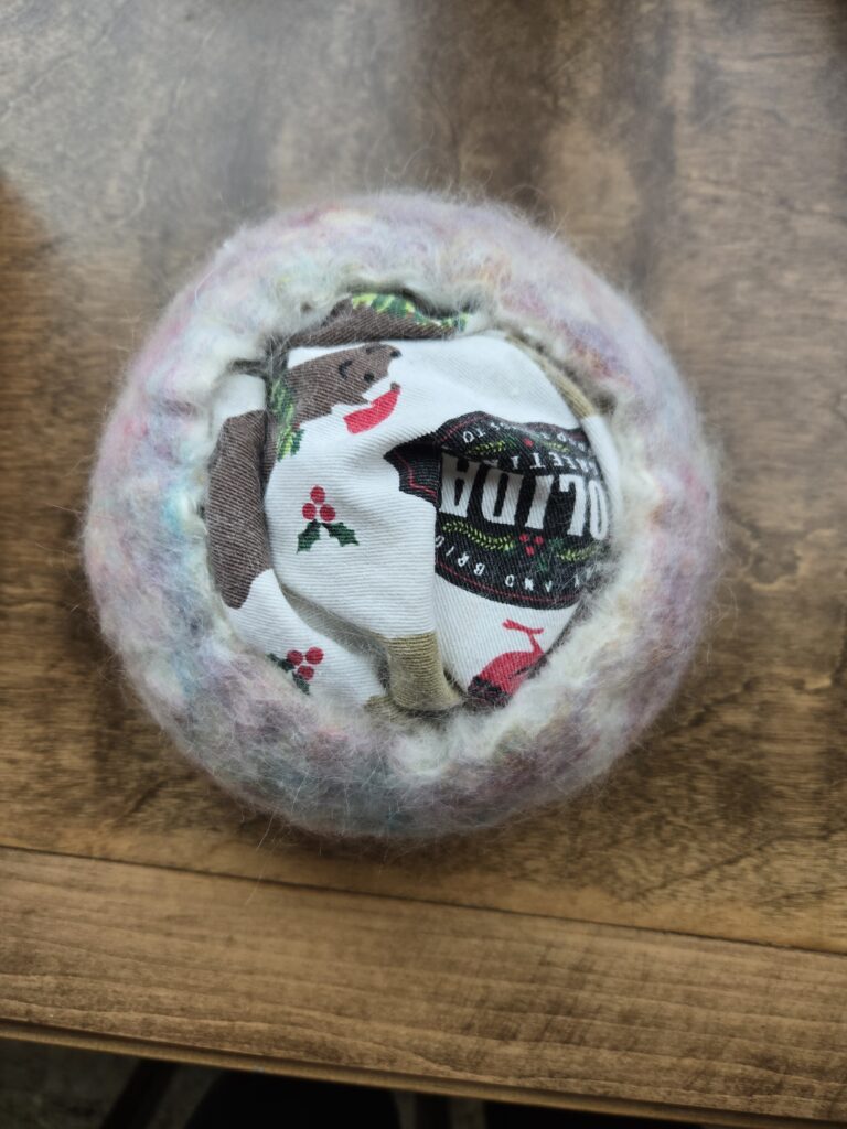 Wet felted bowl stuffed with towels.