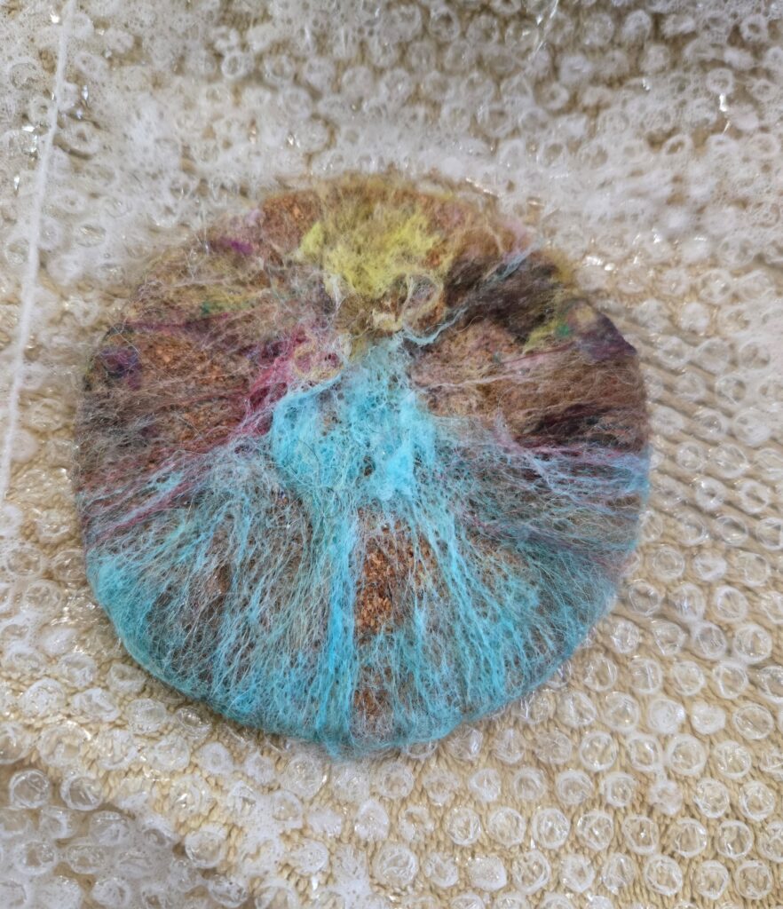 Folding the fiber for a wet-felted coaster