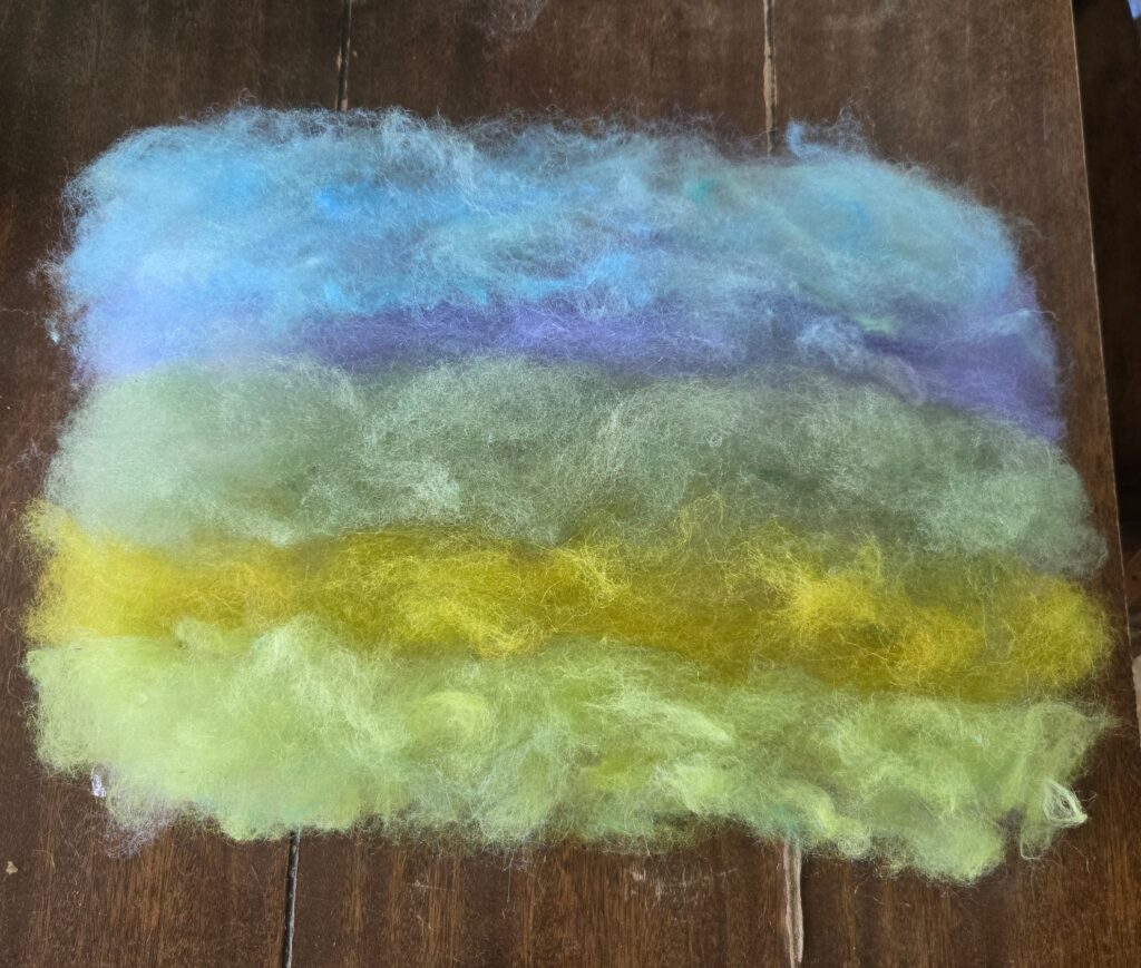 Colors of wool arranged for wet felting.