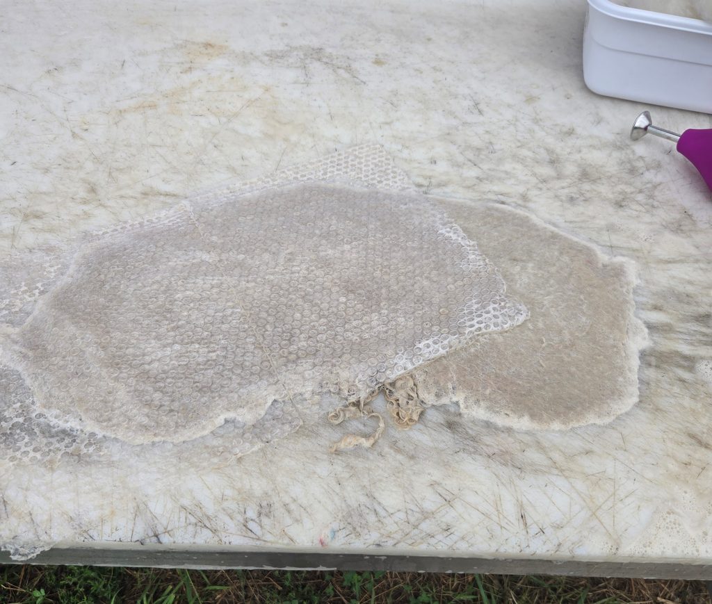 Bubble wrap being used for wet felting.