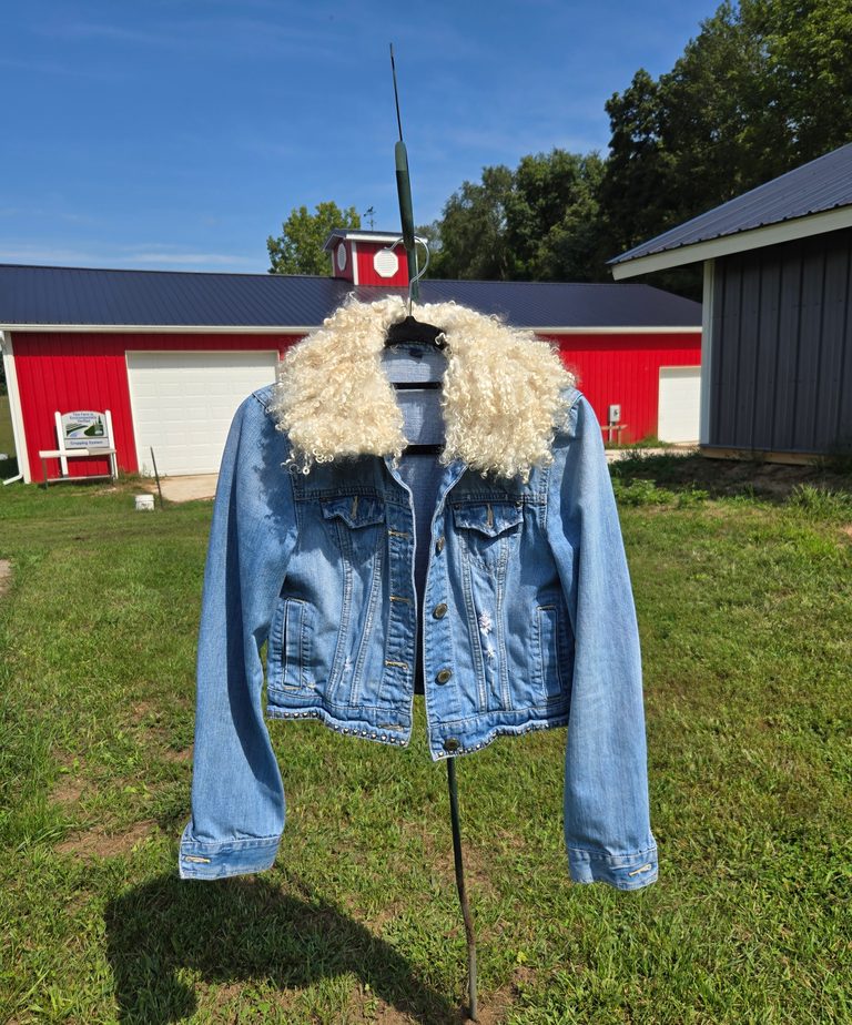 Removable felted fleece collar on a denim jacket.